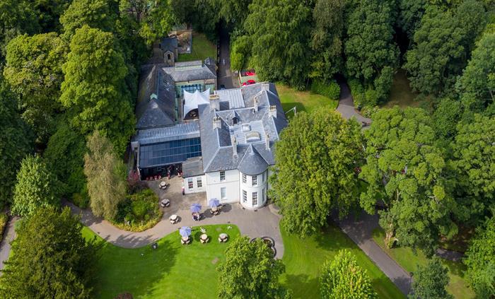 An aerial shot of Bedwellty House featuring the cafe and people enjoying refreshments from the cafe.